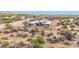 Aerial view of a modern home surrounded by desert vegetation and mountain views at 7261 E Via Dona Rd, Scottsdale, AZ 85266