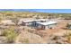Stunning aerial shot of modern home, showcasing its desert landscape and mountain views at 7261 E Via Dona Rd, Scottsdale, AZ 85266