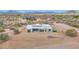 High aerial perspective of modern home, situated in a desert landscape with other homes nearby at 7261 E Via Dona Rd, Scottsdale, AZ 85266