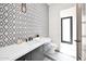 Powder bathroom featuring modern tiling, black fixtures, and bright lighting at 7261 E Via Dona Rd, Scottsdale, AZ 85266
