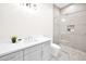 Bathroom featuring walk-in shower with pebble floor, grey vanity, and white countertops at 7261 E Via Dona Rd, Scottsdale, AZ 85266