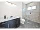 Beautiful bathroom featuring walk-in shower with black hexagonal floor and grey tile surround at 7261 E Via Dona Rd, Scottsdale, AZ 85266