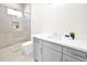 Bright bathroom featuring walk-in shower with pebble floor, and grey vanity with white countertop at 7261 E Via Dona Rd, Scottsdale, AZ 85266