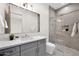 Modern bathroom with a gray vanity, quartz countertop, and glass-enclosed shower at 7261 E Via Dona Rd, Scottsdale, AZ 85266
