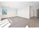 Spacious, bright room with hardwood flooring and two windows, ready to be transformed into your dream space at 7261 E Via Dona Rd, Scottsdale, AZ 85266