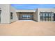 Modern home's open-air rear patio, featuring sleek design and desert views through expansive sliding glass doors at 7261 E Via Dona Rd, Scottsdale, AZ 85266