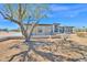 Modern desert home featuring clean lines and neutral tones in a spacious setting with mature tree at 7261 E Via Dona Rd, Scottsdale, AZ 85266