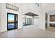Open-concept foyer featuring high ceilings, tile floors, clerestory windows, and seamless transition to dining at 7261 E Via Dona Rd, Scottsdale, AZ 85266