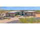 Eye-catching modern home with manicured desert landscaping and stone facade accents at 7261 E Via Dona Rd, Scottsdale, AZ 85266