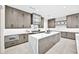 Stylish kitchen with a large island, marble counters, custom cabinets, and stainless steel appliances at 7261 E Via Dona Rd, Scottsdale, AZ 85266