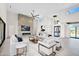 Bright living room featuring stone fireplace, high ceilings, tile floors, and modern white furniture at 7261 E Via Dona Rd, Scottsdale, AZ 85266