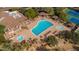 Aerial view of the community pool with lap lanes, a spa, and recreational areas, surrounded by lush landscaping at 7414 E Oasis St, Mesa, AZ 85207