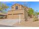 Charming two-story residence with a triple-car garage and desert landscaping, set beneath a bright blue sky at 7414 E Oasis St, Mesa, AZ 85207