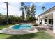 Serene backyard with sparkling pool, mature trees, and a comfortable lounge area at 7435 E Corrine Rd, Scottsdale, AZ 85260