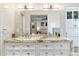 Bathroom featuring double sinks, vanity, large mirror, and modern fixtures at 7435 E Corrine Rd, Scottsdale, AZ 85260