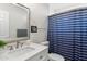Charming bathroom with modern vanity, framed mirror and shower with a blue striped curtain at 7435 E Corrine Rd, Scottsdale, AZ 85260