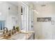 Elegant bathroom with a glass-enclosed shower featuring decorative tile and stone countertops at 7435 E Corrine Rd, Scottsdale, AZ 85260