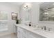 Modern bathroom featuring double sinks, vanity, and a framed mirror with overhead lighting at 7435 E Corrine Rd, Scottsdale, AZ 85260