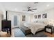 Bedroom featuring a ceiling fan, dresser, exterior access, and an en-suite bathroom at 7435 E Corrine Rd, Scottsdale, AZ 85260