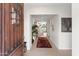 Inviting foyer with decorative rug, view to kitchen, and elegant front door at 7435 E Corrine Rd, Scottsdale, AZ 85260