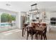 Modern kitchen featuring white cabinets, stainless steel appliances, and an adjacent dining area at 7435 E Corrine Rd, Scottsdale, AZ 85260