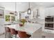 Modern kitchen with a large center island, pendant lighting, stainless steel appliances, and white cabinetry at 7435 E Corrine Rd, Scottsdale, AZ 85260