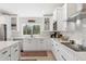 Well-lit kitchen featuring white cabinets, stainless appliances, granite counters, and tile backsplash at 7435 E Corrine Rd, Scottsdale, AZ 85260