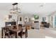 Open-concept living and dining area with modern lighting, fireplace, and neutral decor at 7435 E Corrine Rd, Scottsdale, AZ 85260