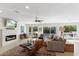 Spacious living room with fireplace, modern furniture, and sliding glass doors to the pool area at 7435 E Corrine Rd, Scottsdale, AZ 85260