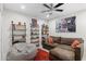 Cozy bonus room with comfy beanbag, sofa, ceiling fan, and custom bookshelves at 7435 E Corrine Rd, Scottsdale, AZ 85260