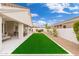 Lush backyard featuring a covered patio, an artificial lawn, and serene outdoor space at 7717 E Black Rock Rd, Scottsdale, AZ 85255