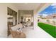 Elegant covered patio with cozy furniture and a sliding glass door entrance at 7717 E Black Rock Rd, Scottsdale, AZ 85255
