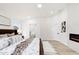 Bright main bedroom with a glimpse into the ensuite bathroom and a cozy fireplace at 7717 E Black Rock Rd, Scottsdale, AZ 85255