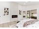 Comfortable main bedroom featuring a modern fireplace and access to the outdoor patio at 7717 E Black Rock Rd, Scottsdale, AZ 85255