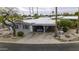 An aerial view of a charming single-story home featuring a covered parking area and desert landscaping at 8240 E Pueblo Ave, Mesa, AZ 85208