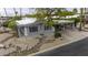 An aerial view of a well-maintained single-story home and desert landscaping with street view at 8240 E Pueblo Ave, Mesa, AZ 85208
