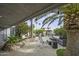 Outdoor living space featuring a well-maintained patio, lush landscaping, palm trees, and string lights at 8240 E Pueblo Ave, Mesa, AZ 85208