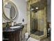 Elegant bathroom featuring an ornate vanity, an oval mirror, and stone tiled shower at 8240 E Pueblo Ave, Mesa, AZ 85208