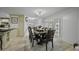 Spacious dining room boasts an elegant table for eight, an ornate light fixture, and open layout at 8240 E Pueblo Ave, Mesa, AZ 85208