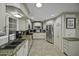 Galley kitchen featuring granite countertops, stainless steel appliances, white cabinetry and tile flooring at 8240 E Pueblo Ave, Mesa, AZ 85208
