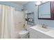This bathroom features a shower-tub combination, a rack for linens and a vanity with a white sink and a framed mirror at 8401 N 55Th Ave, Glendale, AZ 85302
