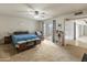 Cozy bedroom featuring a king-size bed, sliding glass door to backyard, and a ceiling fan at 8401 N 55Th Ave, Glendale, AZ 85302