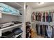 Walk-in closet featuring dual hanging rods, storage shelves, and shoe racks for optimal organization at 8401 N 55Th Ave, Glendale, AZ 85302