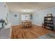 Dining room with a round table, wood-look floors, and ample natural light at 8401 N 55Th Ave, Glendale, AZ 85302