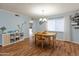Bright dining room with a wood table set and natural light streaming through the window at 8401 N 55Th Ave, Glendale, AZ 85302