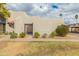 The exterior of the home features a low-maintenance landscape, desert shrubbery, and a sidewalk for easy access at 8401 N 55Th Ave, Glendale, AZ 85302