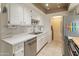 Well-lit kitchen featuring stainless steel appliances, white cabinets, and stylish backsplash at 8401 N 55Th Ave, Glendale, AZ 85302
