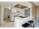 Modern kitchen with white cabinets, stainless steel appliances, and a breakfast bar with stool seating at 8401 N 55Th Ave, Glendale, AZ 85302
