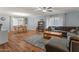Open-concept living and dining area with wood-look floors and a large sectional sofa at 8401 N 55Th Ave, Glendale, AZ 85302