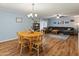 Open floor plan featuring a dining area with wood-look floors and view to the living room at 8401 N 55Th Ave, Glendale, AZ 85302